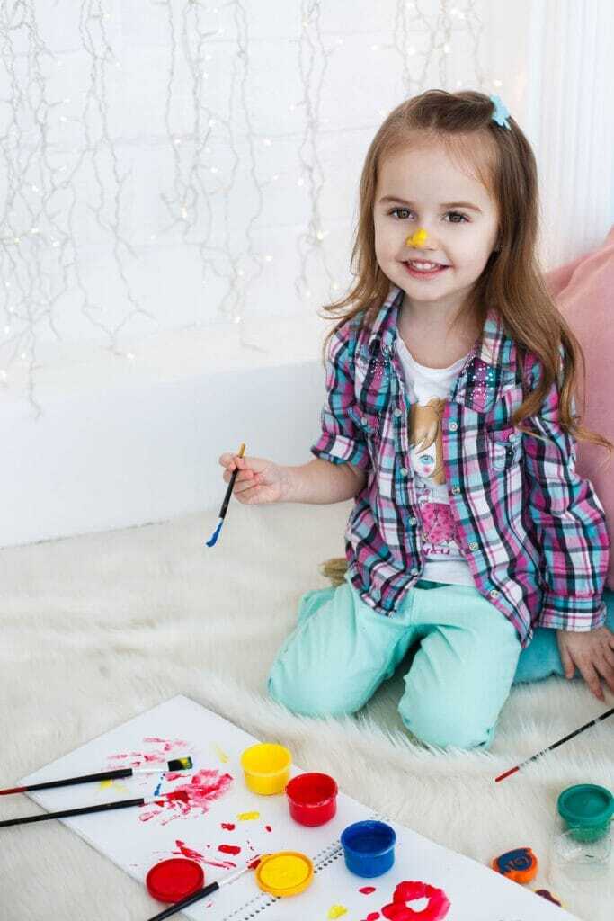 charming-little-girl-blue-yellow-paints-floor