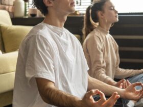full shot couple meditating together scaled