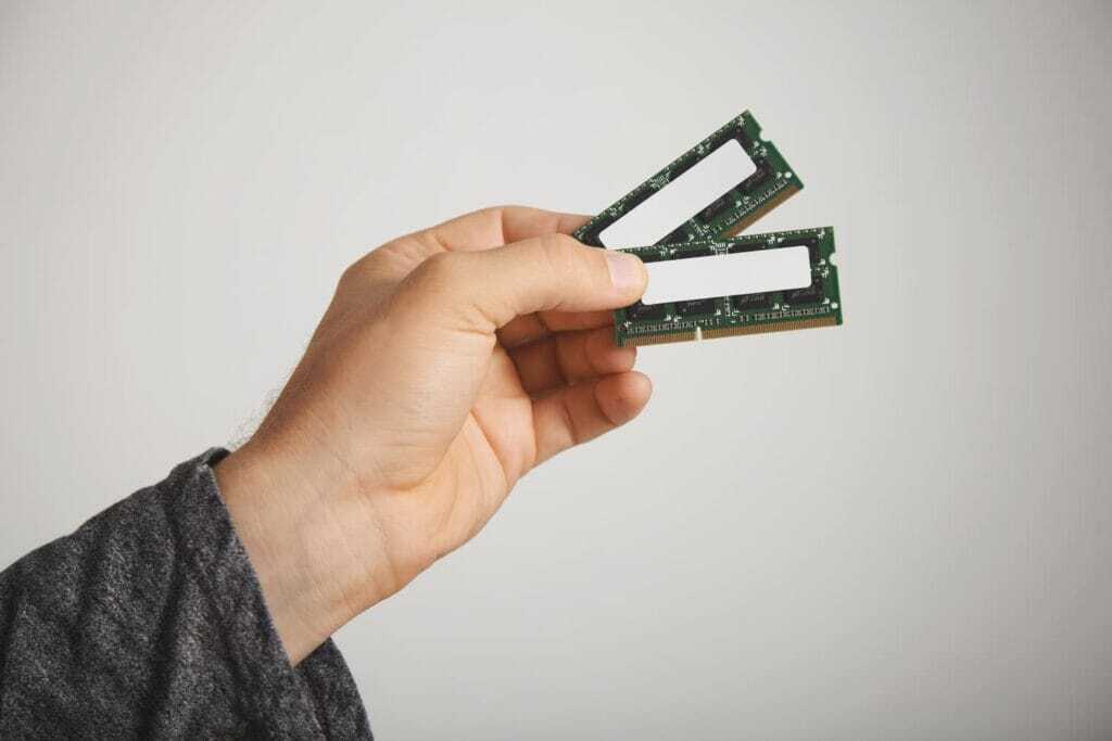two-ram-chips-man-s-hand-isolated-white