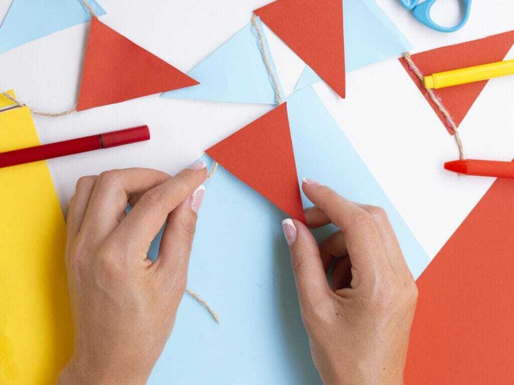 woman-making-decorations-blue-paper