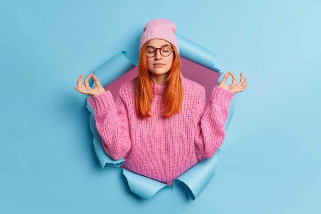 young-calm-relaxed-woman-holds-hands-yoga
