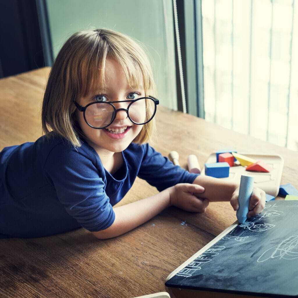 young-girl-lying-drawing-board